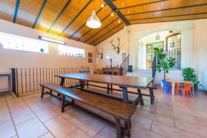 a large room with a wooden table and benches at Finca Can Valero in La Aranjasa