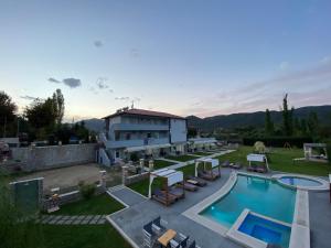a house with a swimming pool and a building at A Ponte Studios & Apartments in Sykia Chalkidikis