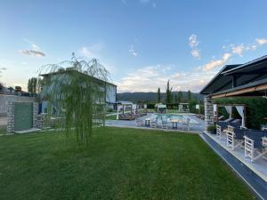a house with a yard with chairs and a building at A Ponte Studios & Apartments in Sykia Chalkidikis