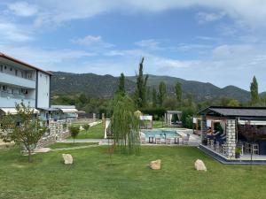 a resort with a swimming pool and a building at A Ponte Studios & Apartments in Sykia Chalkidikis