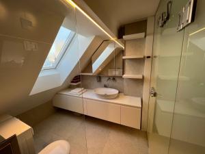 a bathroom with a sink and a window at Gloria Holiday - Apartment Bohinj in Bohinj