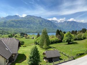 an aerial view of a house with mountains in the background at Gloria Holiday - Apartment Bohinj in Bohinj