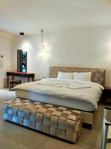 a large bed with a large ottoman in a bedroom at Casa Blanca in Fethiye