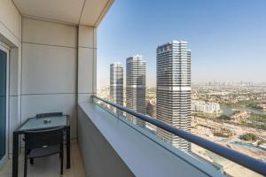 a balcony with a desk and a view of the city at Royal Club By RVHR, Bonnington Residential Tower - JLT in Dubai