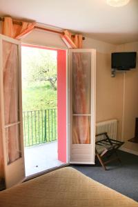 an open door with a view of a balcony at Hôtel Sampiero Corso in Corte