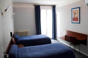 Postel nebo postele na pokoji v ubytování Hôtel Sampiero Corso