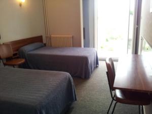 Postel nebo postele na pokoji v ubytování Hôtel Sampiero Corso