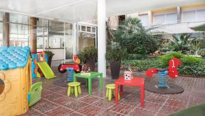 a room with colorful chairs and tables in a building at Apartaments Costa d'Or in Calafell