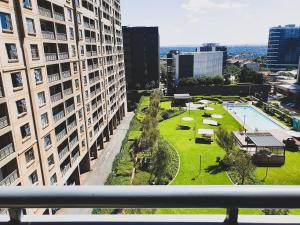a view from the balcony of a building with a park at Westpoint Sandton Apartments in Johannesburg