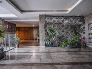 a lobby with potted plants on a wall at Hotel Europa Starachowice in Starachowice