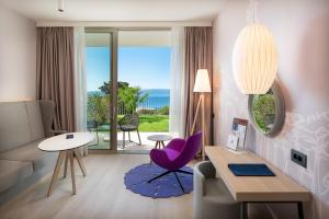 a living room with a table and a purple chair at Radisson Blu Resort & Spa in Split