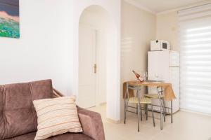 a living room with a couch and a refrigerator at Espanatour AZAHAR DEL MAR in Torrevieja
