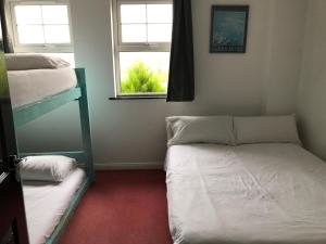 a bedroom with two bunk beds and a window at Finn McCools Giants Causeway Hostel in Bushmills