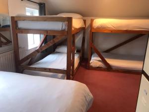 a room with two bunk beds and a bed at Finn McCools Giants Causeway Hostel in Bushmills