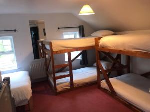 a room with two bunk beds and a mirror at Finn McCools Giants Causeway Hostel in Bushmills