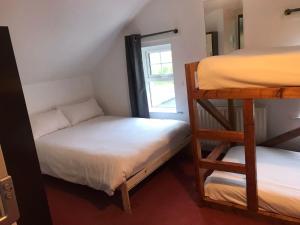 a room with two bunk beds and a window at Finn McCools Giants Causeway Hostel in Bushmills