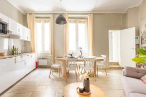 a kitchen and living room with a table and chairs at Edwin Suites in Paris