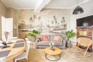 a living room with a couch and a table at Edwin Suites in Paris