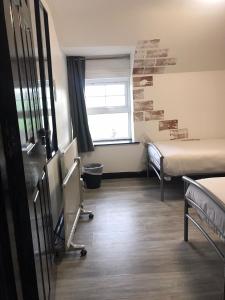 a hospital room with two beds and a window at Finn McCools Giants Causeway Hostel in Bushmills