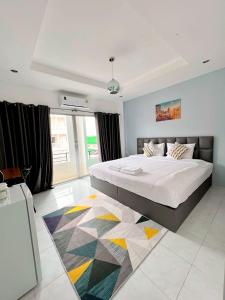 a bedroom with a large bed and a large window at Nap at 265 Donmeaung in Bangkok