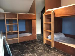 a room with three bunk beds in a room at Finn McCools Giants Causeway Hostel in Bushmills