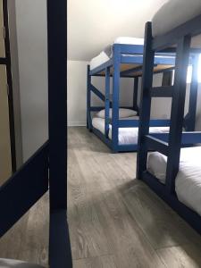 a room with two bunk beds and a mirror at Finn McCools Giants Causeway Hostel in Bushmills