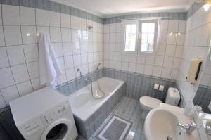 a bathroom with a tub and a toilet and a sink at Villa Leo Junior in Áno Korakiána +19 photos