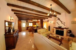 a living room with a couch and a fireplace at Villa Leo Junior in Áno Korakiána