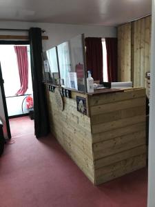 a wooden counter in a room with two windows at Finn McCools Giants Causeway Hostel in Bushmills