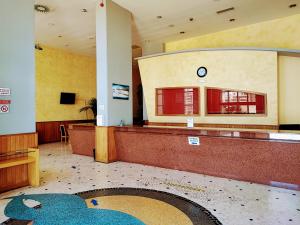 a waiting room with a clock on the wall at Seaview Apartment Clube Praia Mar in Portimão +36 photos