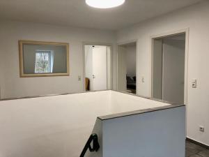 an empty room with a white wall and a window at Dachgeschosswohnung mit Seeblick in Ahrensbök