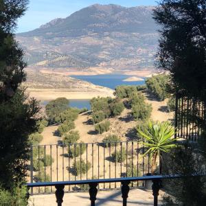 a view of a body of water from behind a fence at Cortijo Rocas Altas in Iznájar