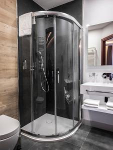 a shower in a bathroom with a toilet and a sink at Hotel Europa Starachowice in Starachowice