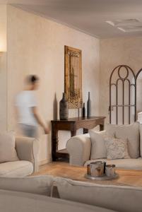 a living room filled with furniture and a large mirror at Porto Naxos in Naxos Chora