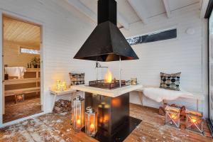 a kitchen with a stove in a room at Robukta Lodge l Jacuzzi l Sauna l Table Tennis in Tromsø