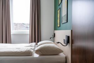 Ліжко або ліжка в номері SLEEEP HOTEL Ansfelden