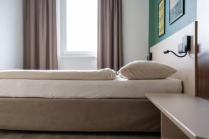 Ліжко або ліжка в номері SLEEEP HOTEL Ansfelden