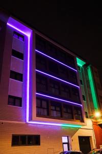 a building with purple and green lights on it at RIBALTA SENSACIONES in Castellón de la Plana
