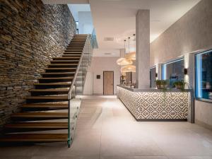 a staircase in a house with a brick wall at Van der Valk Hotel Assen in Assen