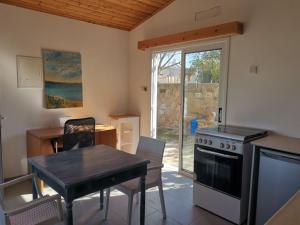 a kitchen with a table and a stove top oven at Wooden House in Paphos