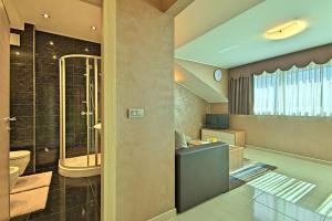 a bathroom with a shower and a toilet and a sink at Apartments Riva-Interauto in Umag +152 photos