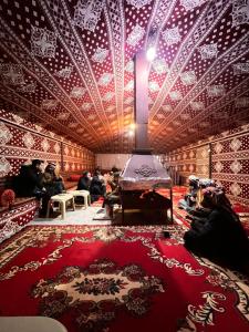 a room with a red and white patterned wall at Wadi Rum Quiet Village Camp in Wadi Rum