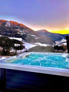 a hot tub with a view of a mountain at Chalet Bergblick in Sankt Blasen