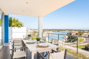 a dining room with a table and chairs on a balcony at Blue Port in Mahón