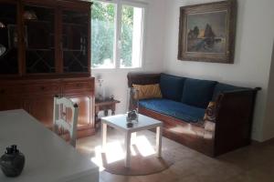 a living room with a blue couch and a table at Villa CHRISALB 1 in Aix-en-Provence