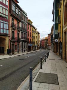 an empty street with buildings on the side of the road at Casa Nacho by Delabra Apartments in Oviedo