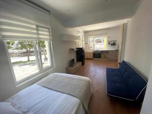 a bedroom with a bed and a blue chair at Grupo Gontad Apartamento Mourelle Corme in Corme-Puerto