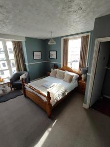 a bedroom with a bed in a room with blue walls at Valentine Guest House in Weymouth +18 photos