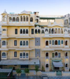 a large yellow building with a lot of windows at Amar Kothi in Udaipur