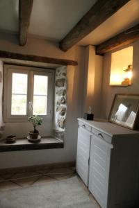 a kitchen with a window and a plant on a counter at Eyhera Perkain in Aldudes